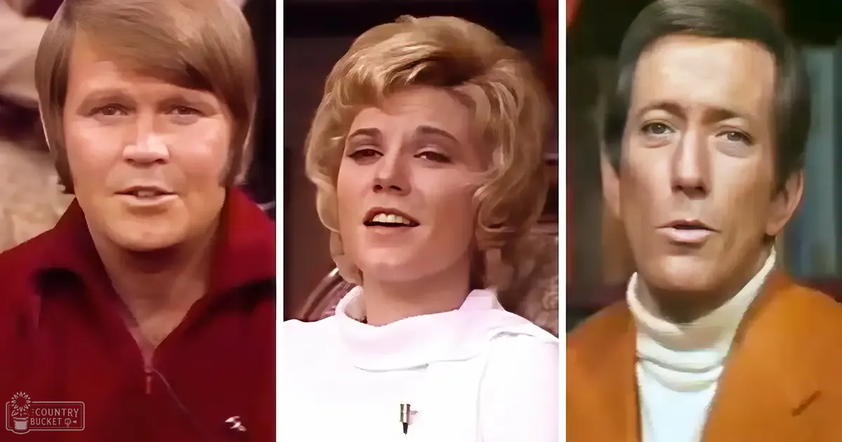 Three adults dressed in late 1960s or early 1970s fashion stand on a stage-like set with artificial lighting, suggesting an indoor television show or performance setting.