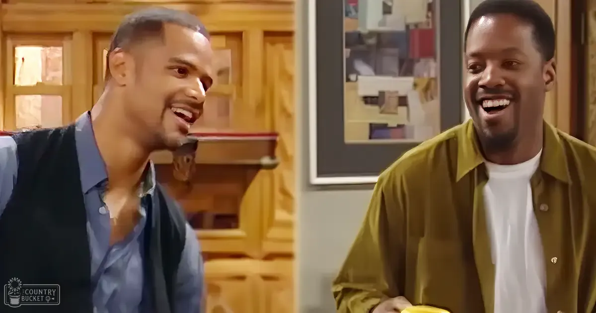 Two young adult males in casual indoor attire, one wearing a dark blue button-up shirt and the other in a mustard yellow button-down over white, surrounded by neutral-toned furniture and abstract artwork.