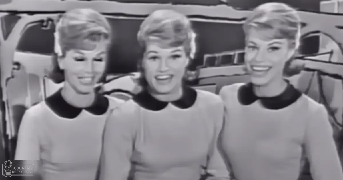 Three young adult females in a studio setting wearing collared dresses with Peter Pan collars and light-colored, smooth fabrics.