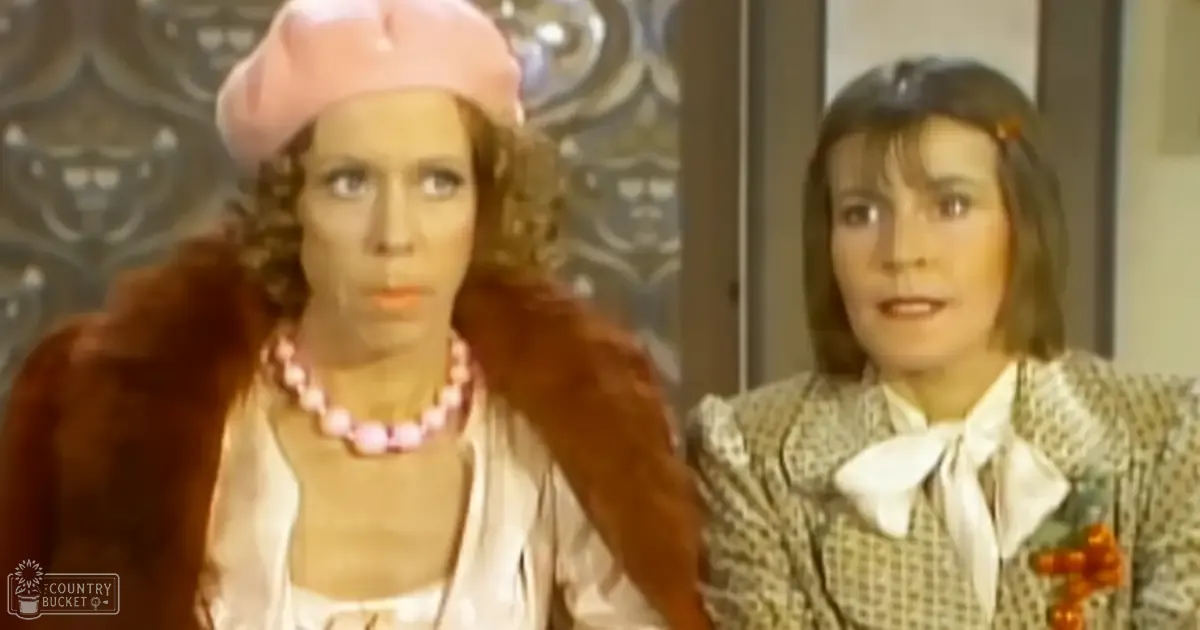 Two women dressed in retro-style clothing from the mid-20th century, wearing vintage accessories and standing indoors against ornate wallpaper.