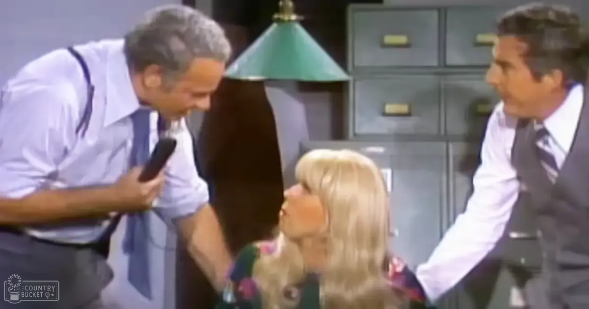 An office scene with three individuals in a mid-20th-century setting, with filing cabinets, an office chair, and artificial indoor lighting.