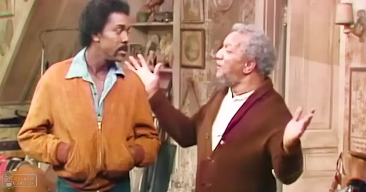 A mid-20th-century indoor setting with a middle-aged man wearing a mustard yellow jacket over a light blue collared shirt, and an older adult in a brown cardigan over a white shirt. Wooden furniture and warm lighting suggest a cozy living room scene.