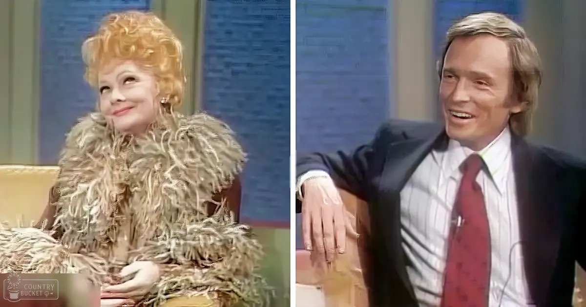 A talk show host and guest in a mid-20th century studio setting, with the host wearing a fluffy light-colored fur coat and the guest in a dark suit jacket over a white shirt with a red tie.