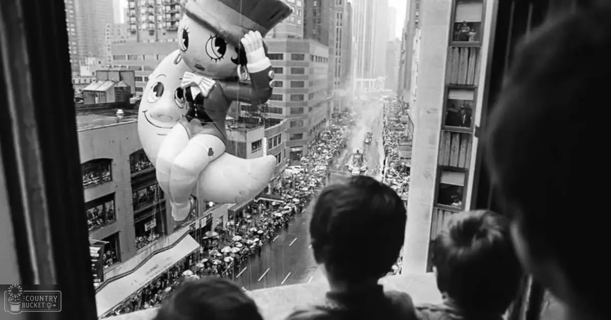 A parade scene with children and adults in an urban setting during the day under overcast skies or late afternoon lighting