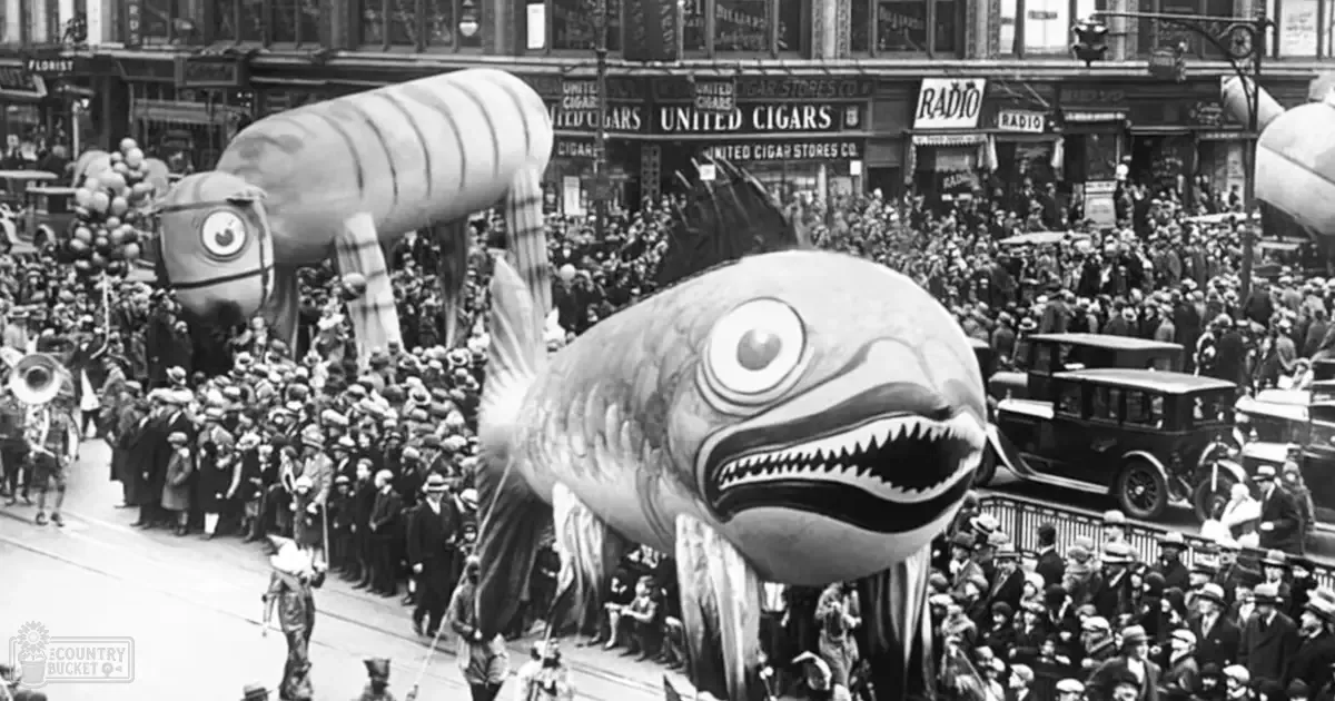 A vibrant parade scene in New York City with large inflatable fish floats, children wearing hats and coats, adults dressed in period-appropriate attire, vintage cars, and clear daylight lighting.