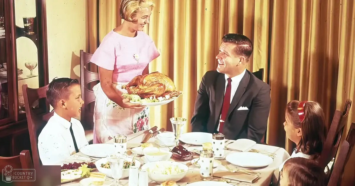 A family of four having dinner at home in a warmly lit dining room with wooden furniture.