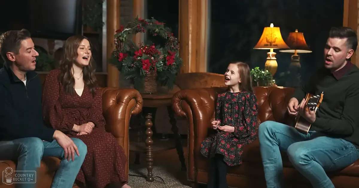 A cozy indoor living room scene with a family with adults in spring or summer attire, rustic furniture, and warm lighting.
