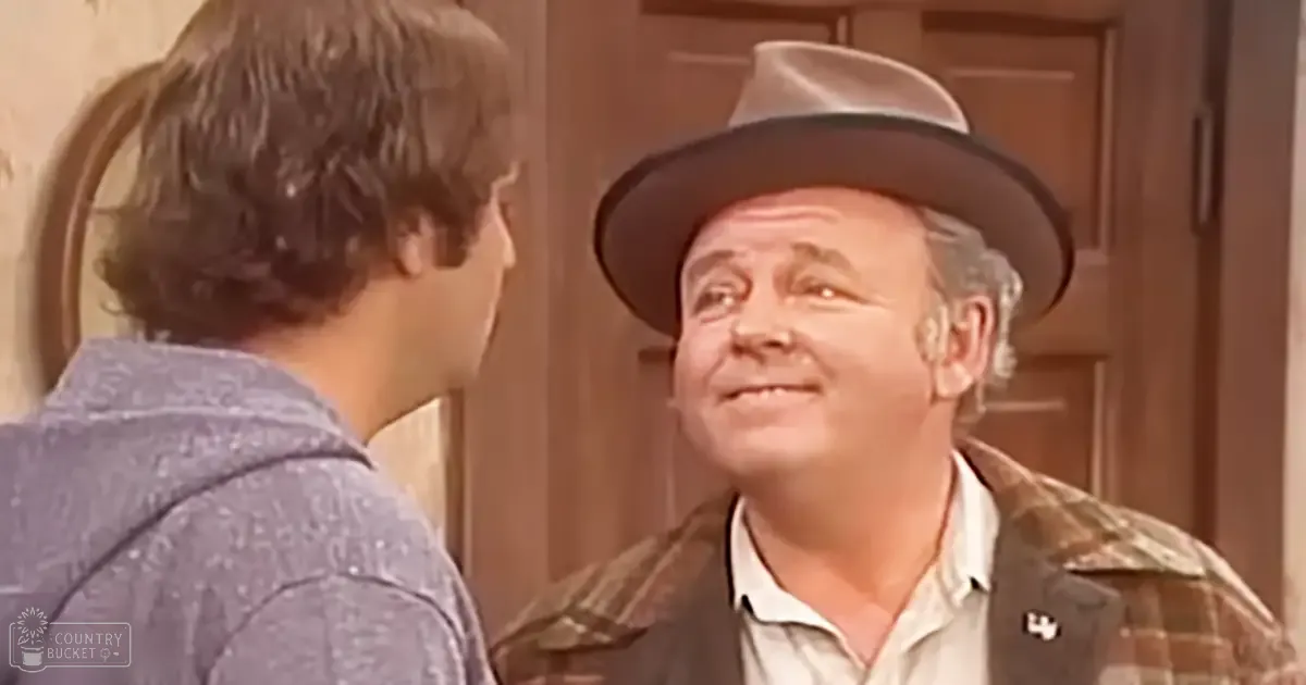 An older adult male and a child in a residential indoor setting with even daylight, wearing vintage-style clothing; wooden door and light-colored wall visible.