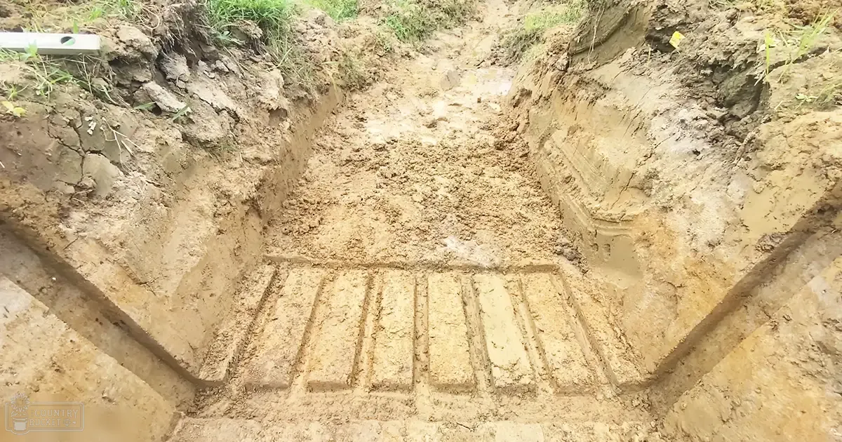 Freshly dug grave site in a rural cemetery with grid pattern, level tool visible, daytime natural light, earthy tones of brown and green dominating.