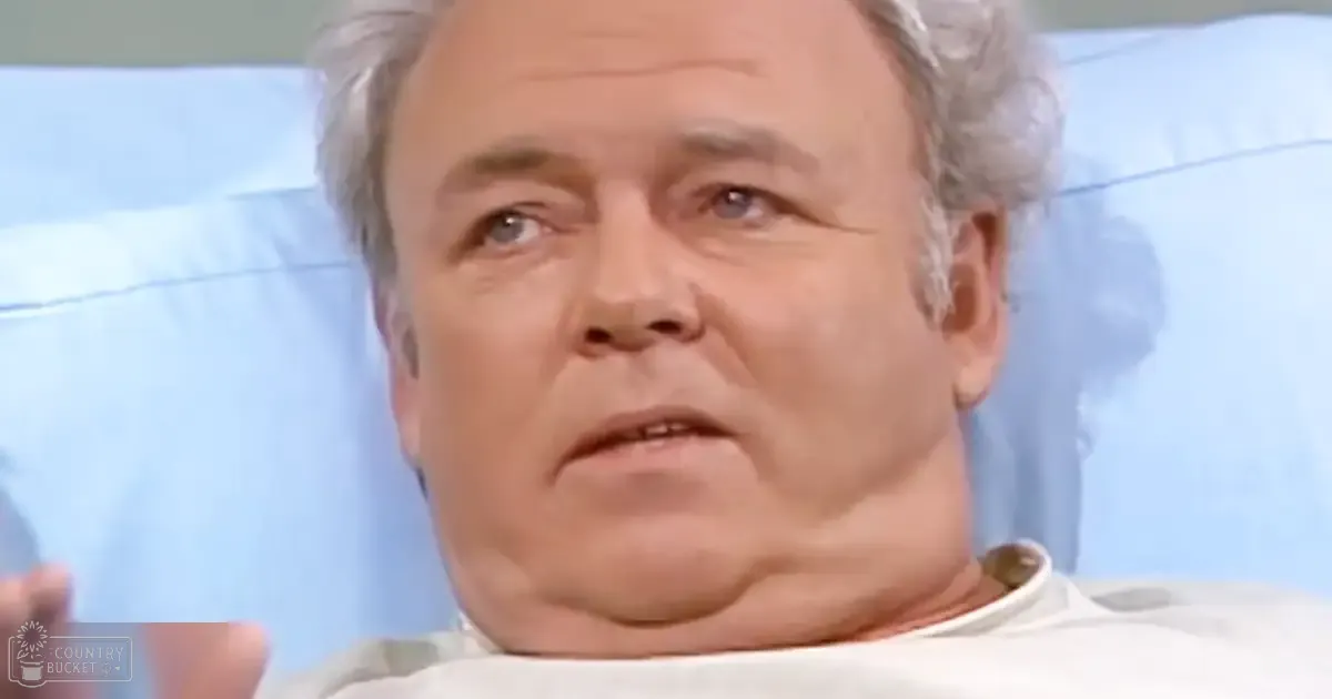 An older adult male in a hospital setting wearing a simple cotton hospital gown.