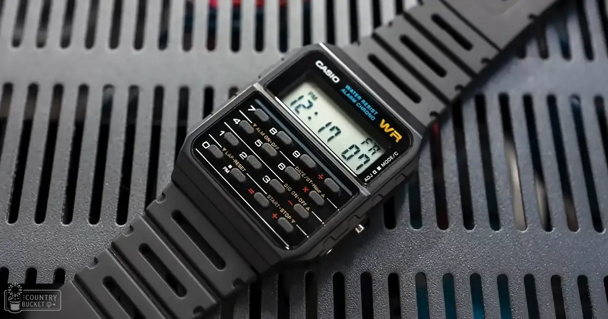 A Casio digital watch with a black face, gray strap, and visible text 'CASIO WATER RESIST ALARM CHRONO' displayed against a metallic background.