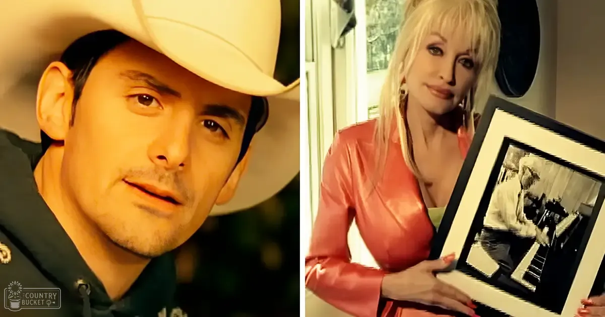 A man and a woman indoors, the man wearing a white cowboy hat and dark green uniform shirt with gold embroidery; the woman in a bright pink satin jacket holding a framed black-and-white photograph of someone playing piano.