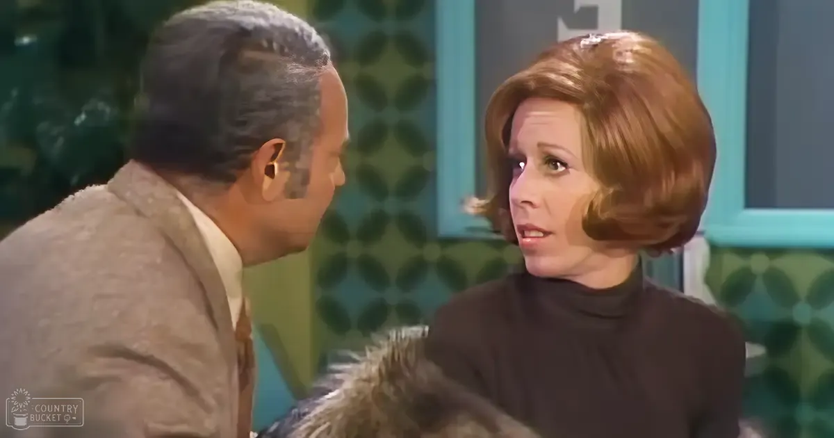 Middle-aged man and woman in a mid-20th century-style indoor setting with vintage wall decor with green and teal patterns.