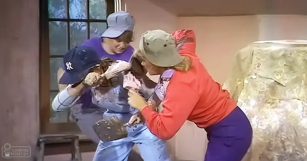 A child wearing a purple shirt and blue jeans indoors near an adult female in red and green attire, with a possible food item on display.