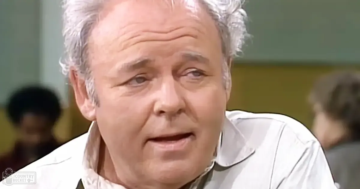 Older adult male wearing a white collared shirt indoors with natural light, muted greens and whites dominate.