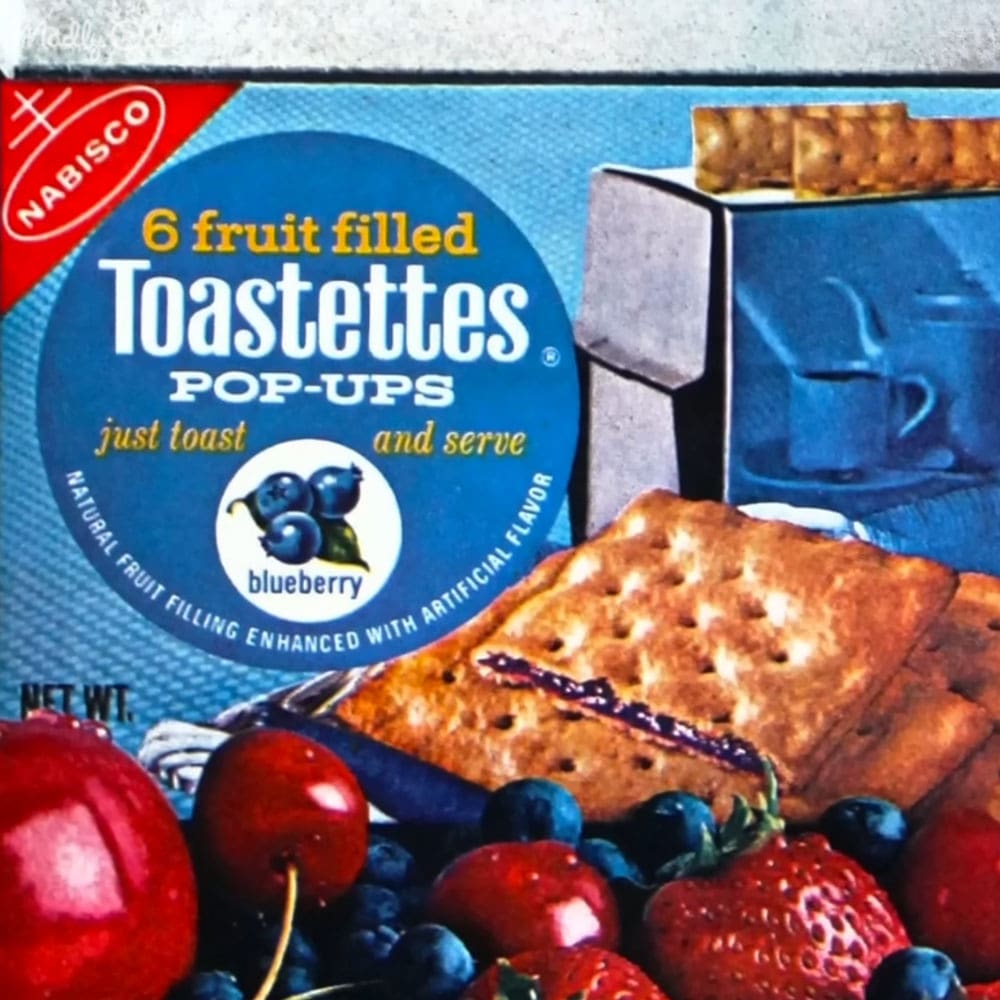 A box of Nabisco Toastettes Pop-Ups fruit-filled crackers with blueberry flavoring displayed in a store setting.