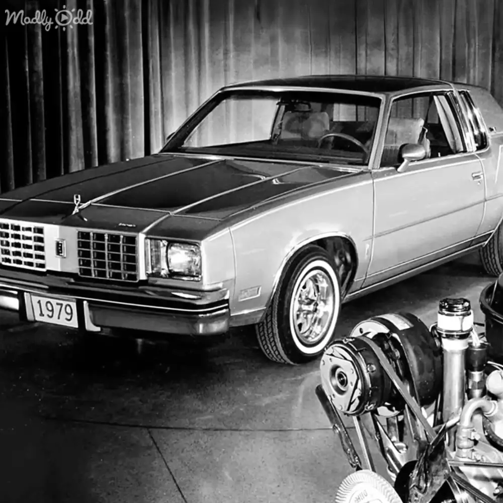 1979 Oldsmobile Cutlass Supreme with chrome details displayed in a showroom setting, front slightly left.