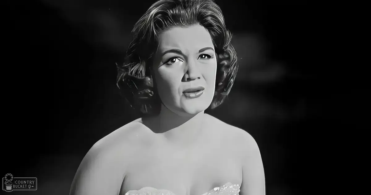 A middle-aged woman wearing a strapless dress with a sweetheart neckline in a studio setting.