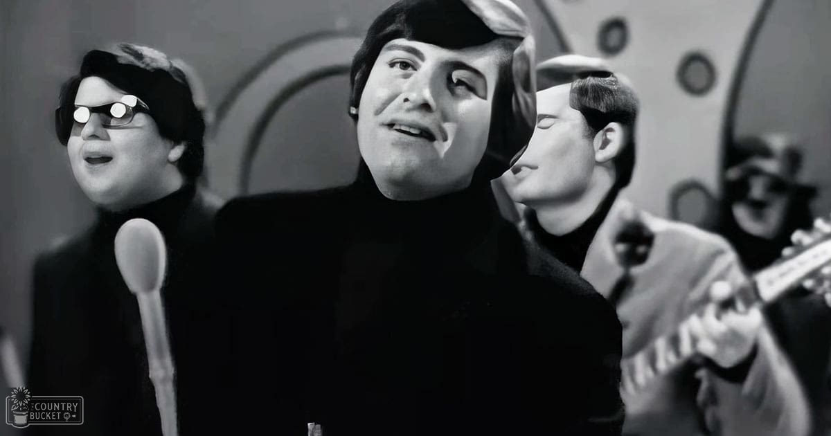 Young adult male in a recording studio setting with microphones and a guitar, wearing dark turtlenecks and jackets, surrounded by professional equipment.