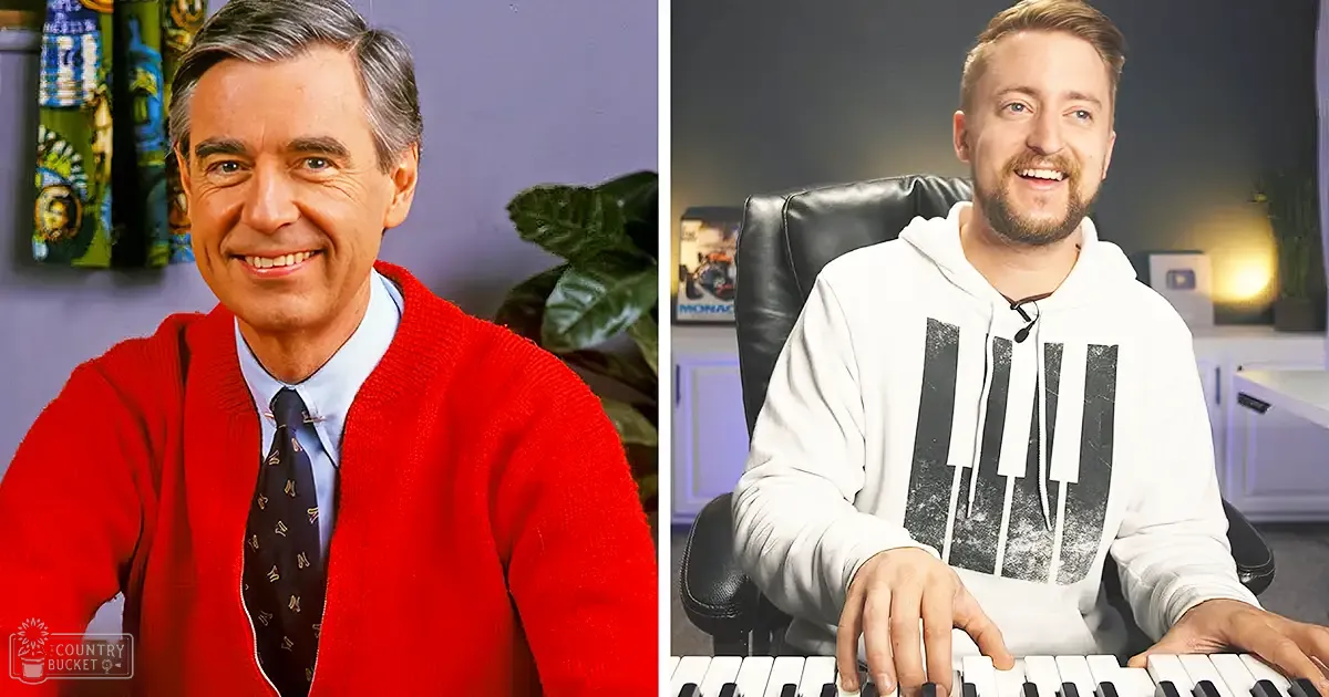 Middle-aged man wearing a red cardigan and light blue collared shirt with dark tie with small patterns sits at a desk in a modern home office setup; young adult male in a white hoodie with black piano keys design sits on an office chair, keyboard in front of him.