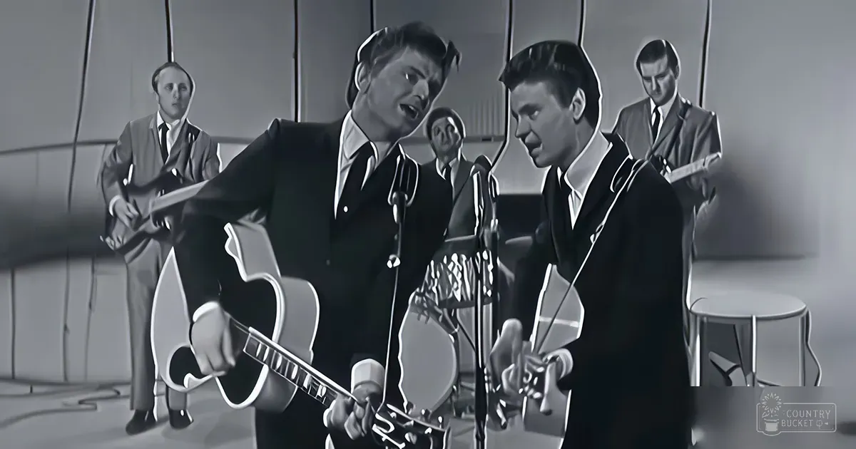 A musical performance scene with young adult male singers in a modern indoor setting, likely a recording studio or stage.