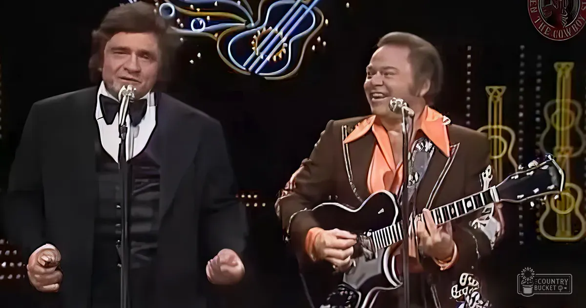 A mid-20th century stage show or concert setting with two adult male performers in formal attire, one wearing a dark suit and white shirt with black bow tie, the other in a brown jacket over an orange shirt with patterned white and black shirt underneath. Decorative neon signs and musical instruments suggest a lively music-themed event.