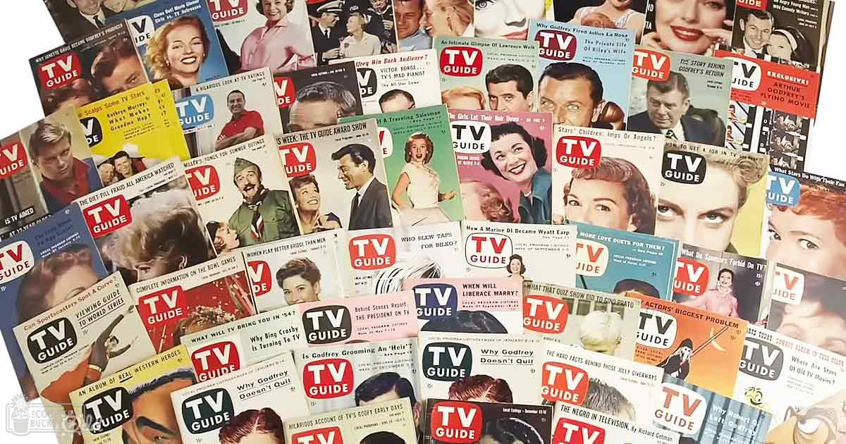 Vintage TV Guide magazines displayed indoors, with mid-20th century fashion on magazine covers with prominent red 'TV GUIDE' logo against various colored backgrounds.