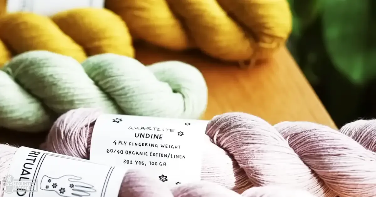 Several skeins of yarn labeled 'QUARTZITE UNDINE' and 'RITUAL', indoors with a wooden surface, natural light or soft artificial lighting.