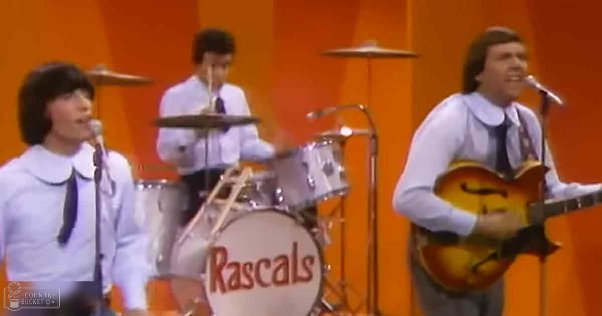 A musical performance by 'The Rascals' in a studio setting with orange backdrop, late 1960s or early 1970s style.