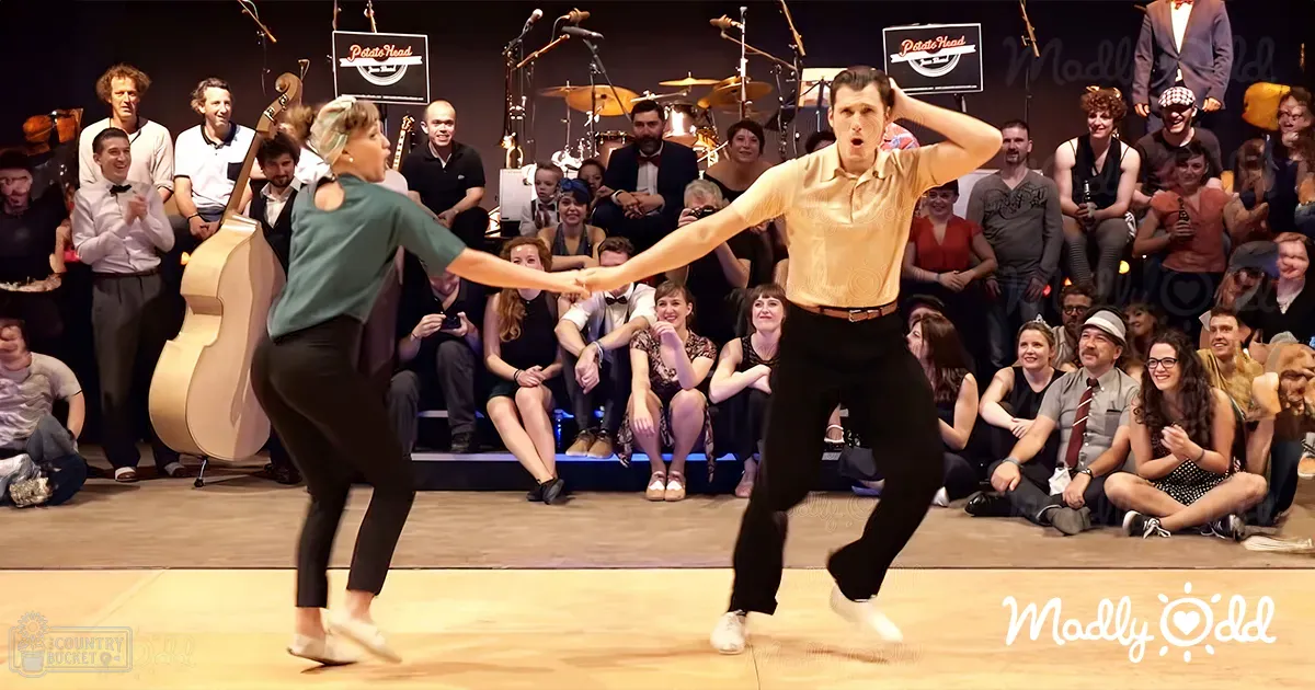 A dance duo performing at 'Potato Head' venue in front of an audience with stage lighting illuminating the performers.