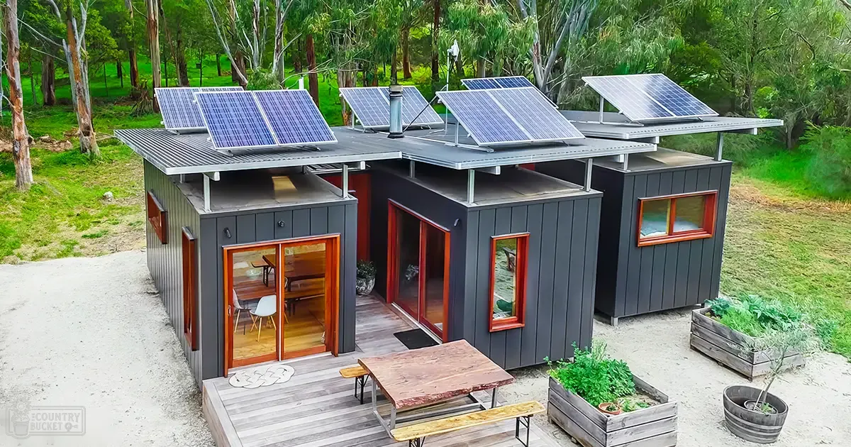 A modern rural solar-powered house surrounded by lush greenery on a sunny day with natural light.