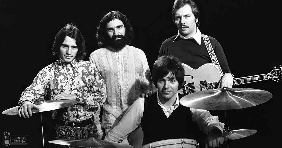 A musical group from the 1960s-1970s era, possibly in a studio setting with young adult males wearing patterned shirts and casual attire.