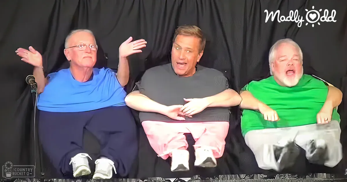 Three adults in a studio setting wearing casual t-shirts and pants with even frontal lighting, black backdrop.