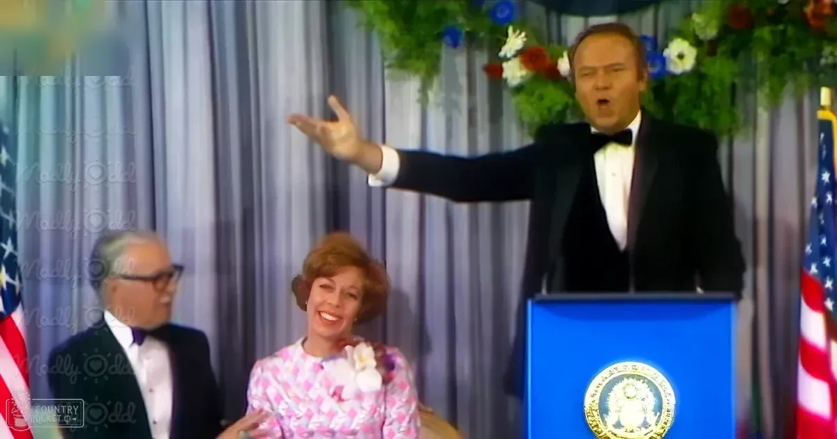 A formal event with a man in a black tuxedo at an official ceremony. A middle-aged woman wears a pink and white checkered dress from the mid-20th century, adorned with a white flower on her shoulder.