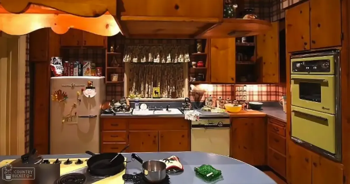 A home kitchen scene with retro-style refrigerator, wooden cabinets, double oven, and green glass dish on a round table.