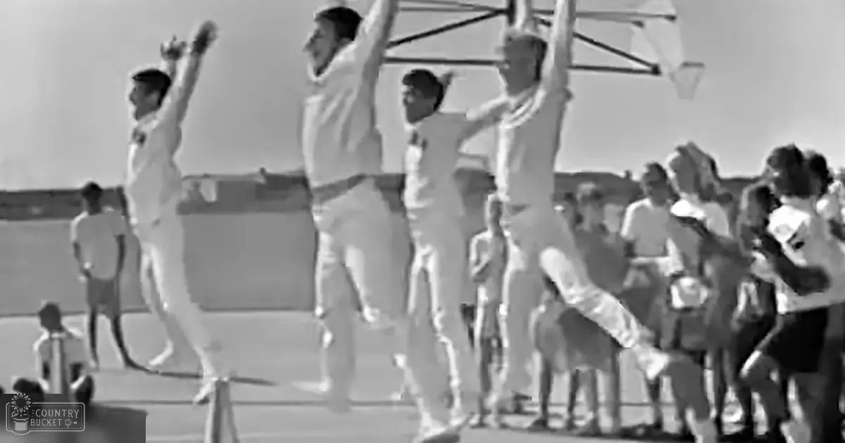 A group of individuals celebrating on a ship deck during what appears to be daytime under bright sunlight.
