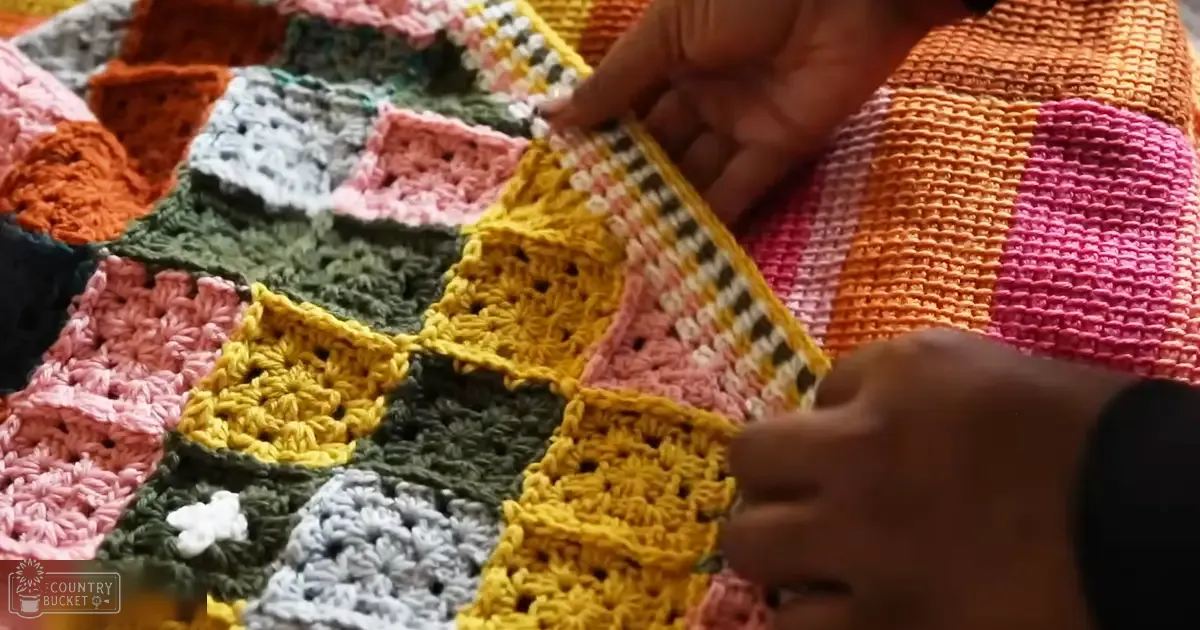 A close-up of a colorful crocheted blanket with hexagonal patterns indoors.