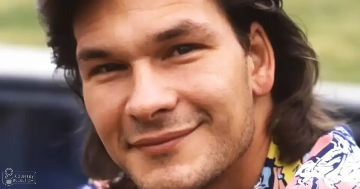 A middle-aged adult male in a patterned shirt with vibrant colors stands outdoors amidst greenery, under natural daylight.