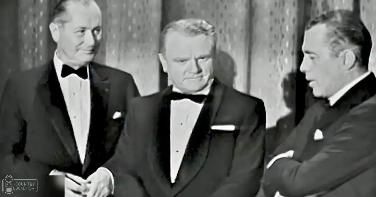Adult males in formal 1930s-1940s tuxedos, social event indoors with patterned curtains and even lighting.