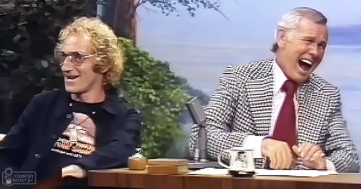 A talk show host interacts with an older adult male guest in a studio setting designed for a talk show.