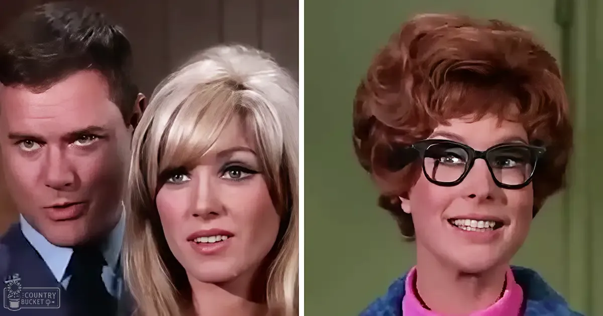 Indoor scene from a television show or movie set in an indoor environment with simple backdrop, likely 1960s or early 1970s. Adult male singer wearing uniform with blue shirt and tie; adult female singer in light-colored top with collar; older adult woman in textured patterned garment over pink inner layer.