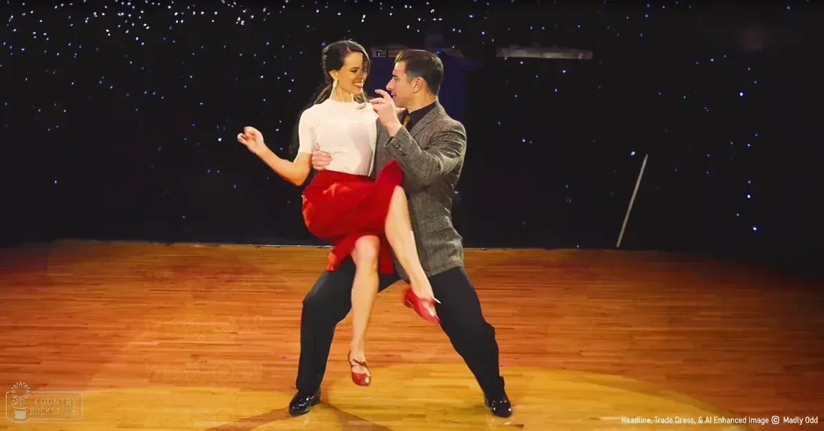 A young adult female and an adult male dancing together on a dark stage adorned with small white dots resembling stars or lights, suggesting it's part of a dance performance in a studio setting.