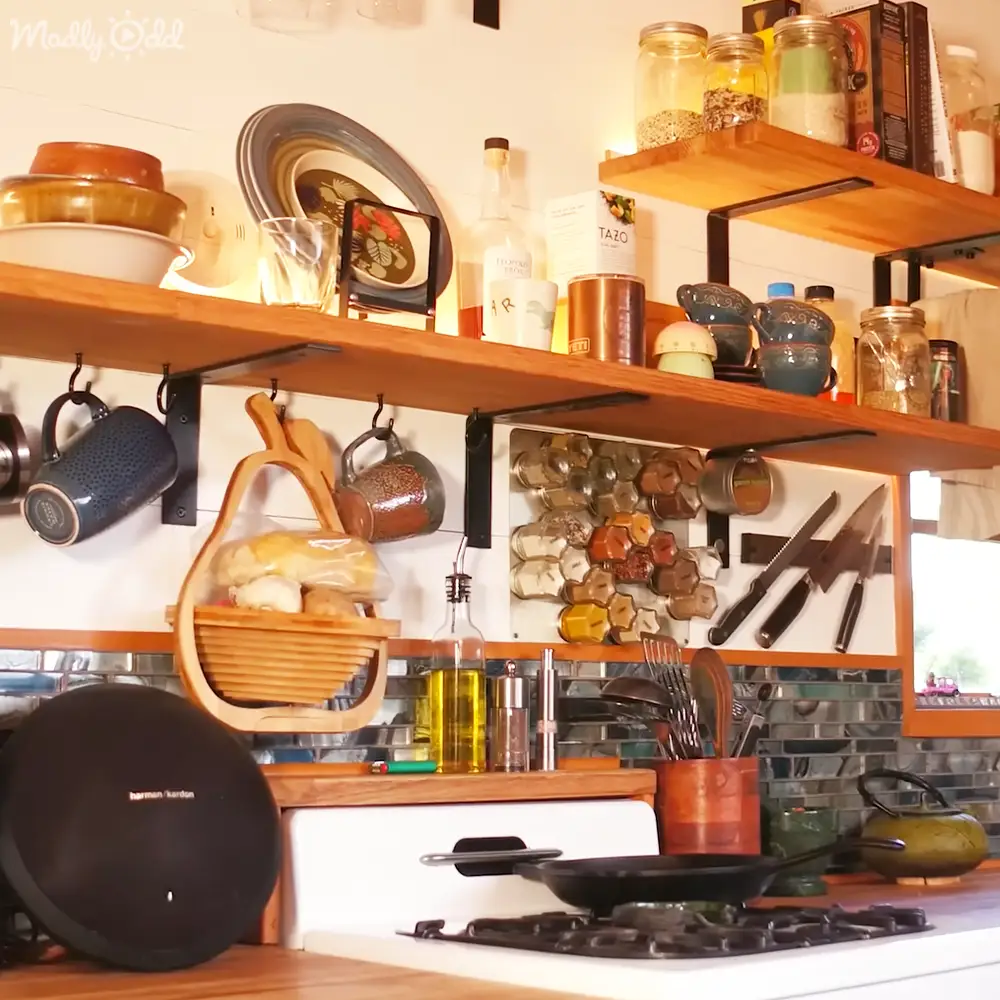 A daytime indoor kitchen scene filled with various kitchenware and ingredients, showcasing earthy tones and natural light.