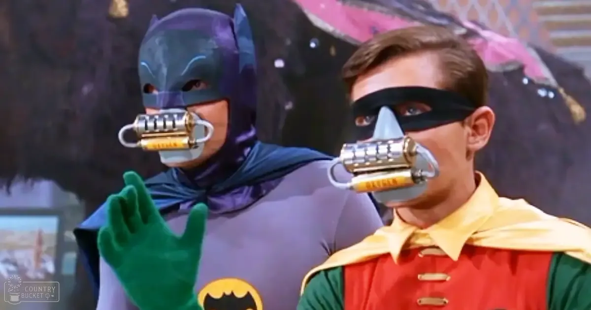 Batman and Robin in a 1960s TV show set resembling Gotham City, with vibrant costumes and bat-themed backdrop.