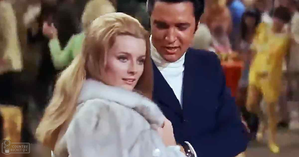 Adult male and female figures dressed in mid-20th century fashion at a social gathering or event, wearing fur coats and formal suits.