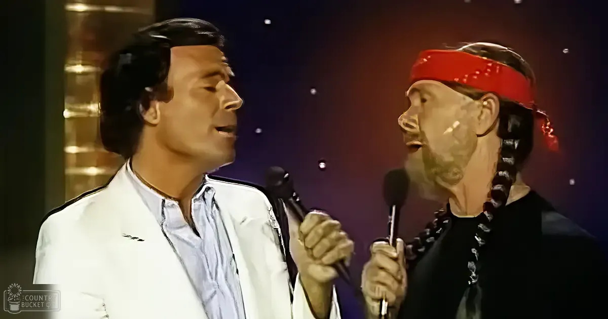 Two adult male singers performing a duet, wearing formal and casual attire against a dark stage backdrop with dramatic lighting effects.