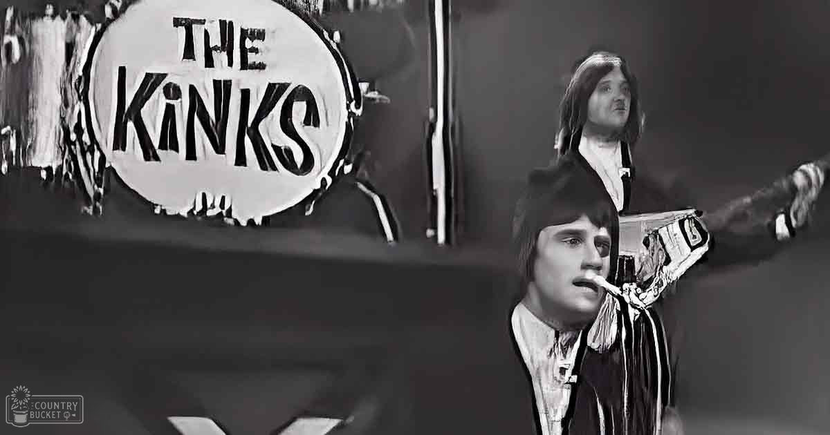 A musical performance with 'The Kinks' at an indoor venue with stage lighting.