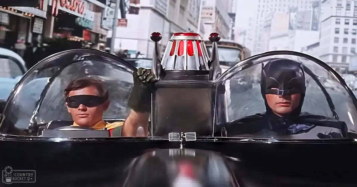 Batman scene with Batmobile and two young adult male drivers in a mid-20th-century urban setting.