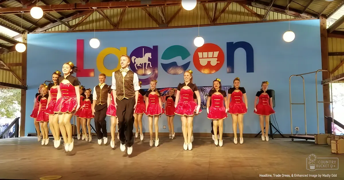 A dance group performing at an event called 'Lagoon' in a large hall or barn-like structure with wooden beams and hanging lights.