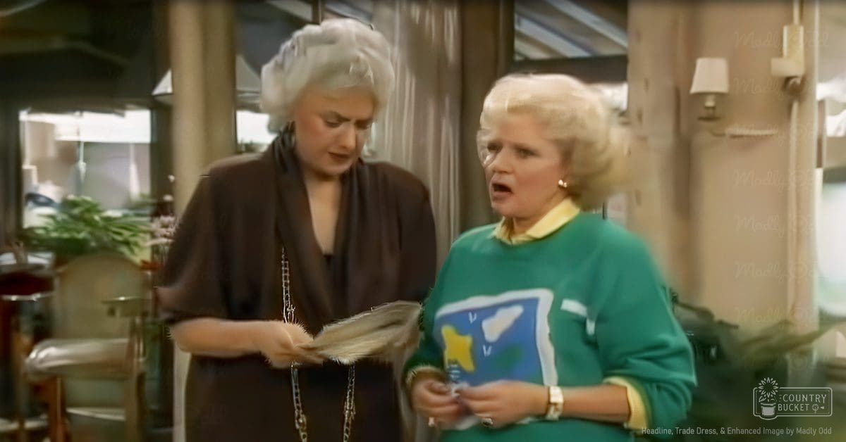 Two middle-aged women in an indoor setting, possibly a home or office, wearing distinct outfits and accessories with natural lighting.